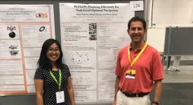 Researchers stand by their poster at conference in Stockholm
